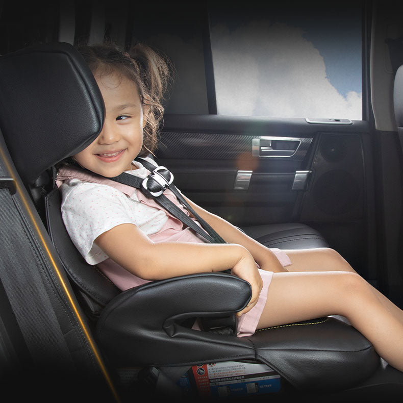 Smiling child wearing a pink travel safety vest secured in a car seat, promoting portable car seat products by Kontenl.